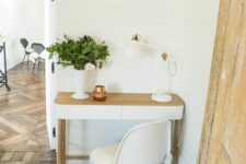 a small and cozy nook with a rounded table and a white Panton chair, a lamp and some greenery is chic and cool