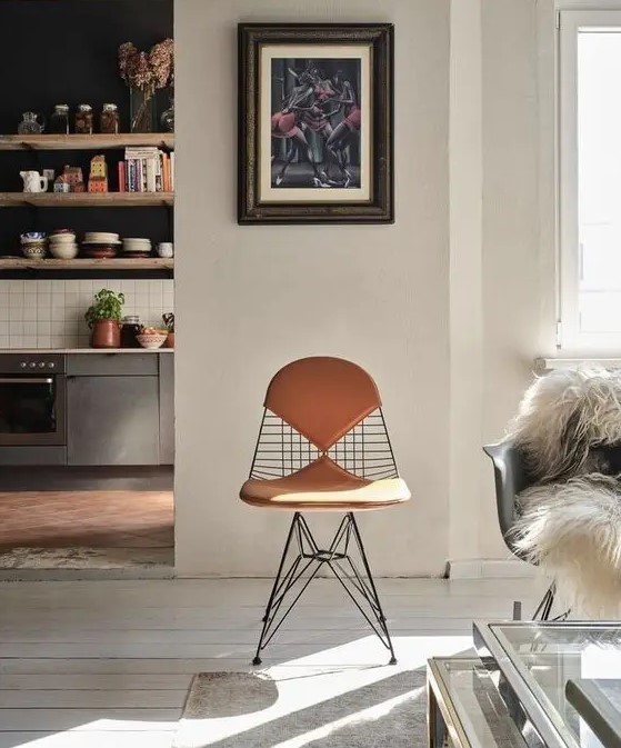 an Eames wire chair with leather seat pads looks more eye catchy and is more comfortable to sit on, you may get some for indoors