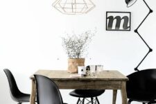 an eclectic Scandinavian dining space with a vintage stained table, black chairs including Panton, a pendant lamp and a floor one
