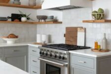 11 a modern farmhouse kitchen with grey shaker cabinets, white stone countertops, a zellige tile backsplash, open shelves