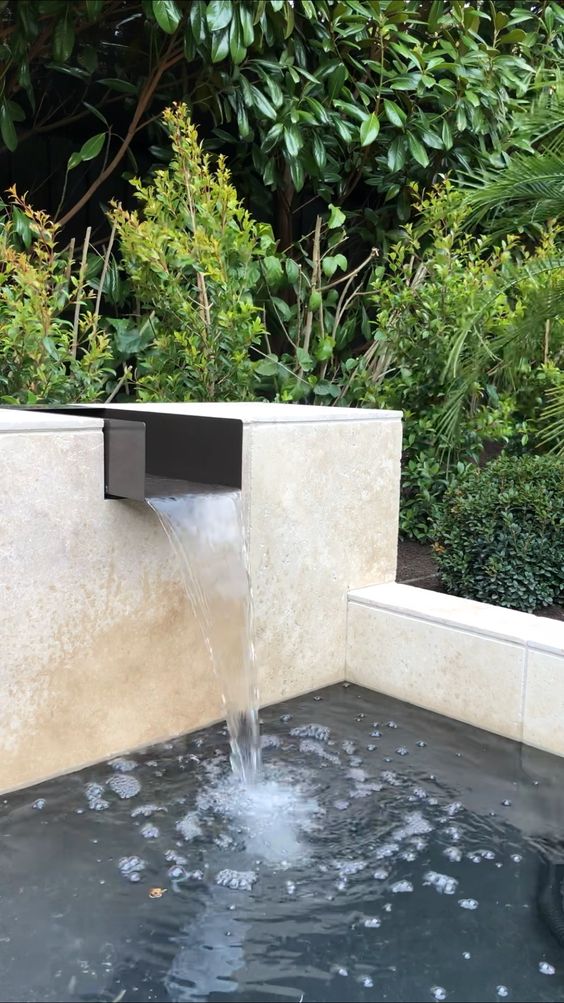 a modern waterfall with a large water feature is a cool idea for a modern garden, it looks laconic and stylish