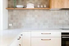 16 a neutral modern kitchen with fluted cabinets, a zellige tile backsplash, open shelves and a wood clad hood