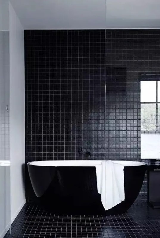 a beautiful contemporary bathroom in black, with small scale tiles, a sleek black bathtub and a black vanity is a lovely idea