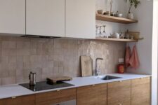 21 a two-tone kitchen with neutral and stained cabinets, a white countertop and a beige Zellige tile backsplash