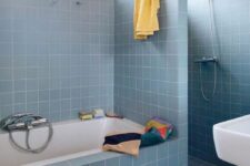 a cute blue bathroom with square tiles
