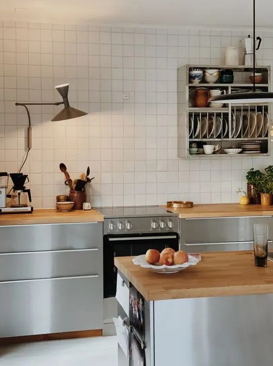 a catchy Nordic kitchen with sleek grey cabinets, butcherblock countertops, a white square tile backsplash and a shelf