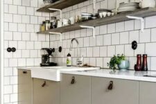31 a greige Scandinavian kitchen with leather pulls, a white square tile wall and open shelves and grey sconces