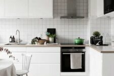 34 a minimal Scandinavian kitchen with sleek white cabinets, stone countertops and a white square tile backsplash