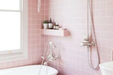 35 a lovely pink bathroom with square tiles, a little shelf and a tiled vanity, white appliances and stainless steel fixtures