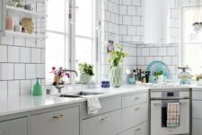 37 a Nordic kitchen with grey lower cabinets, white square tiles on the walls, a round hood and open shelves is lovely