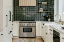 43 a Scandinavian kitchen with shaker cabinets, a dark green square tile backsplash, white stone countertops and a shiplap hood