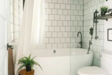 51 a neutral bathroom with white square tiles and a printed tile floor, white appliances, a wooden stool and black fixtures