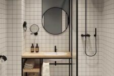 59 a stylish contrasting modern bathroom with white square tiles and a grey ceiling and wall, a shower, a vanity, round mirrors and black fixtures
