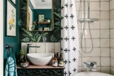a catchy eclectic bathroom with white tiles, botanical wallpaper, a vanity with painted books and printed textiles