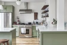 a chic contemporary kitchen in sage green and white, with dark wooden touches and white countertops is very welcoming