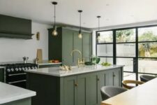 a chic contemporary kitchen with dark olive green cabinets, white countertops, a black cooker and bulbs over the kitchen island