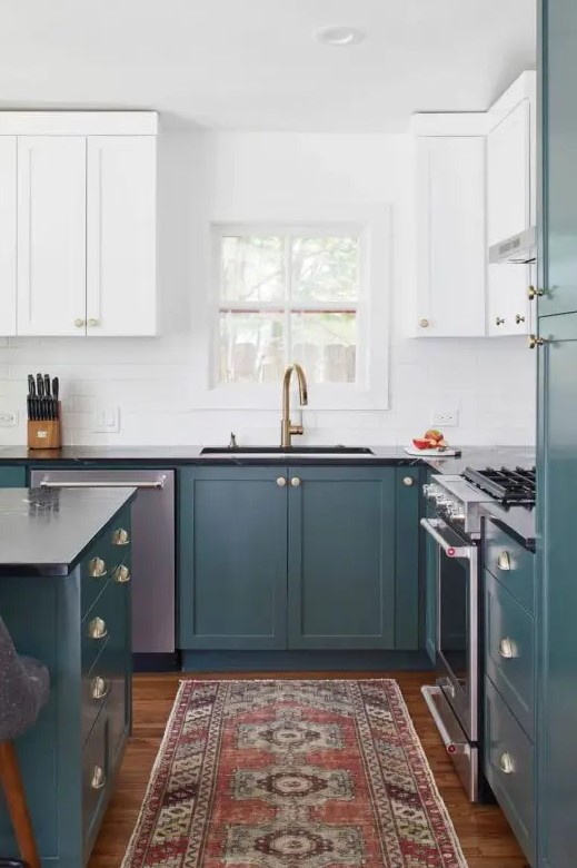 a chic two-tone kitchen with teal and white shaker style cabinets, a white tile backsplash and a bold rug