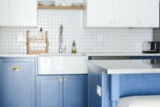 a contemporary kitchen with light blue lower cabinets and white upper ones plus touches of gold