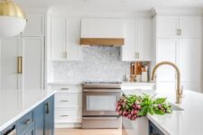 a lovely modern farmhouse kitchen with white upper and egg blue lower cabinets, white stone countertops and pendant lamps