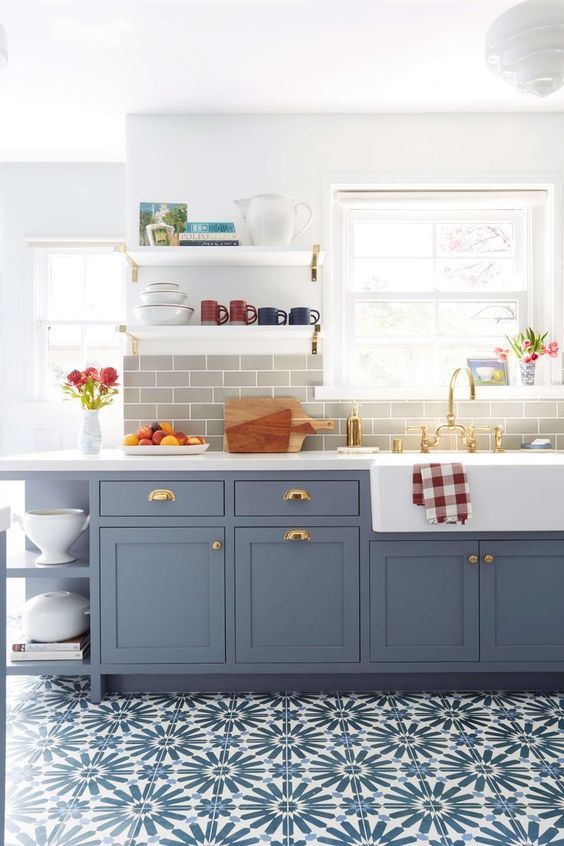a modern farmhouse kitchen with grey shaker cabinets, a grey tile backsplash, a blue tiled floor, open shelves