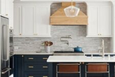 a refined two-tone kitchen with white and navy shaker cabinets, a grey tile backsplash, leather chairs and a pendant lamp