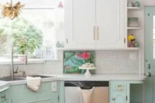 a retro kitchen done in white and mint, with elegant cabinets, white stone countertops, a white penny tile backsplash and gold fixtures