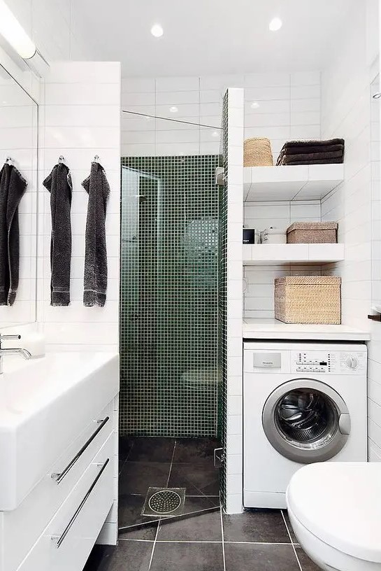 a tiny contemporary bathroom with a tiled shower space, a washing machine, a white vanity and a sink