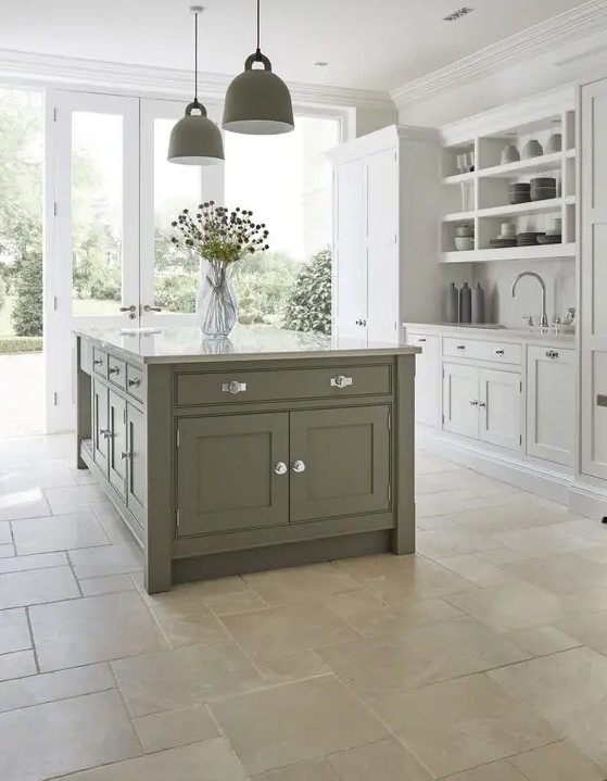 an elegant dove grey and green modern country kitchen with green pendant lamps and a stone floor is a chic and welcoming space
