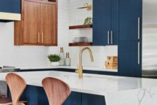 an eye-catching kitchen with sleek navy cabinets, a white tile backsplash, some stained cabinets, a kitchen island with a geo countertop