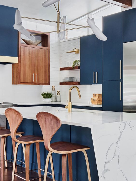 an eye-catching kitchen with sleek navy cabinets, a white tile backsplash, some stained cabinets, a kitchen island with a geo countertop