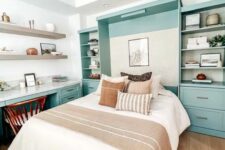 06 a welcoming guest bedroom with a mint blue storage unit and a Murphy’s bed, a matching desk, open shelves