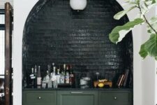 06 an arched niche clad with dark green brick, with a lamp and a some bar done with green cabinets is a fantastic idea