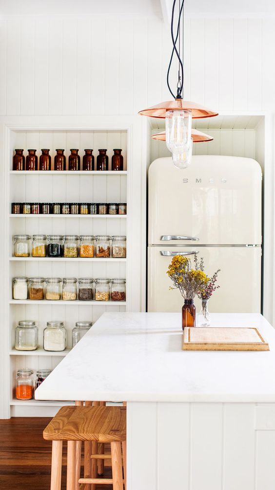 niches used to place a fridge and shelves used for spices and other dry foods in jars are amazing