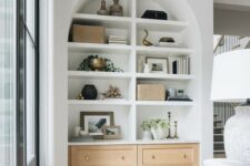 16 a large arched niche with built-in shelves and storage units, with books, decor and artwork is a stylish addition to living room decor
