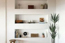 28 a modern space with a wooden ceiling with beams, a parquet floor and three niche shelves for storing stuff