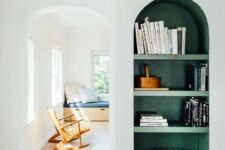 39 a neutral space with a green arched wall niche with shelves, with books and baskets that is a bold color touch to the space