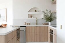 39 a serene contemporary kitchen with stained lower cabinets, stone countertops, open shelves, small niches over the sink that are used for storage