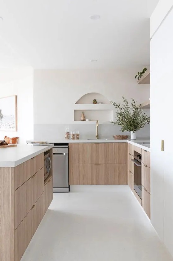 a serene contemporary kitchen with stained lower cabinets, stone countertops, open shelves, small niches over the sink that are used for storage