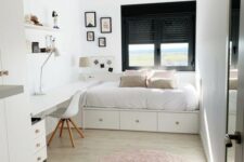 42 a small guest bedroom with a windowsill bed with decor and pillows, a built-in desk and open storage shelves