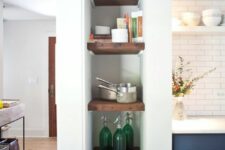 44 a tall and narrow niche with books used for firewood, books, decor and some cookware is awesome