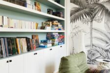 47 a reading nook with built-in niche shelves done green, with cabinets, a green chair, a wall mural and a boho rug is a welcoming space