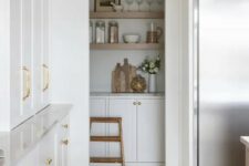 47 a white modern farmhouse kitchen with an arched niche that hides a pantry with cabinets and open shelves, a smart solution to save some pace