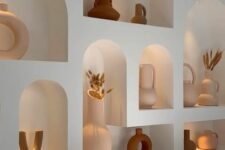51 a whole series of arched lit up niches with lovely ceramic vases is a cool and chic idea for a boho living room