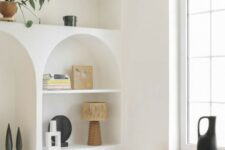 63 niches and arched niches with shelves, with beautiful decor, potted plants and books are great to add interest to the space