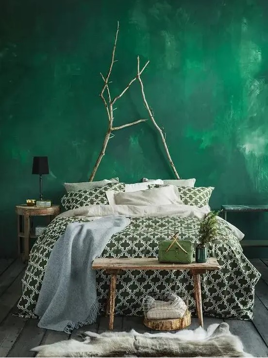 a bold emerald plaster wall plus branches to hint on love to nature and create a bold look