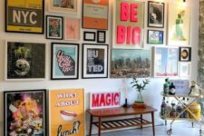 a bright and catchy pop art gallery wall with mismatching frames and bold artworks in this style is amazing