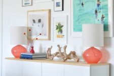 a cheerful vacation-inspired gallery wall with mismatching frames and bright prints and artworks is bold and fun