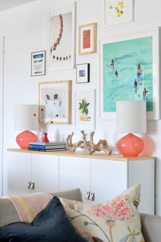 a cheerful vacation-inspired gallery wall with mismatching frames and bright prints and artworks is bold and fun