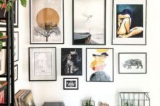 a chic free form gallery wall with thin black frames, white matting and various types of art presented
