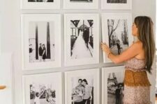 a chic grid gallery wall with matching white frames and black and white family pics is cool and very elegant